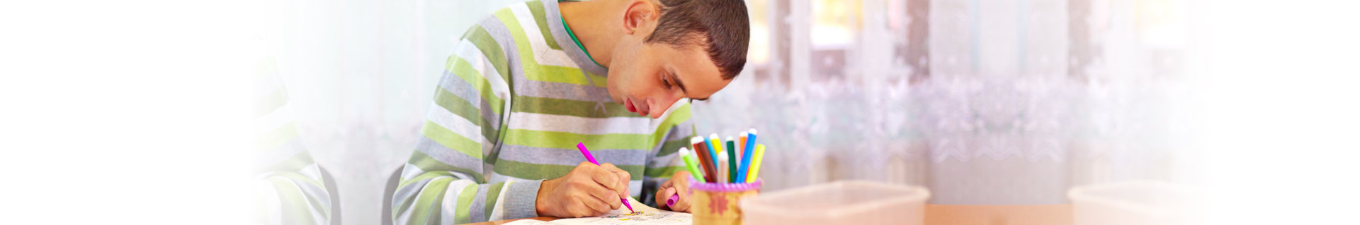 a teen writing on notebook